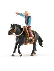 SCHLEICH41416 Ковбой в седле на необъезженной лошади